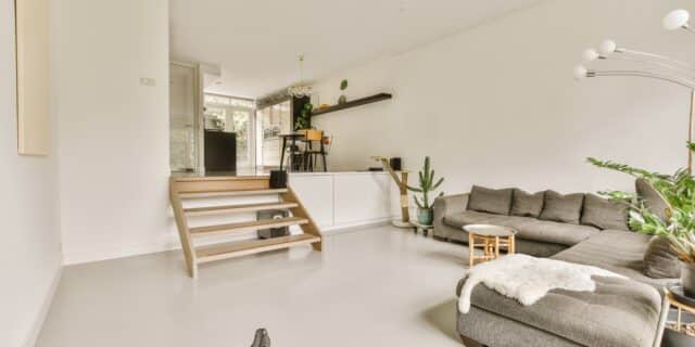 Moderne woonkamer met een strakke gietvloer in project Turfspoor.
